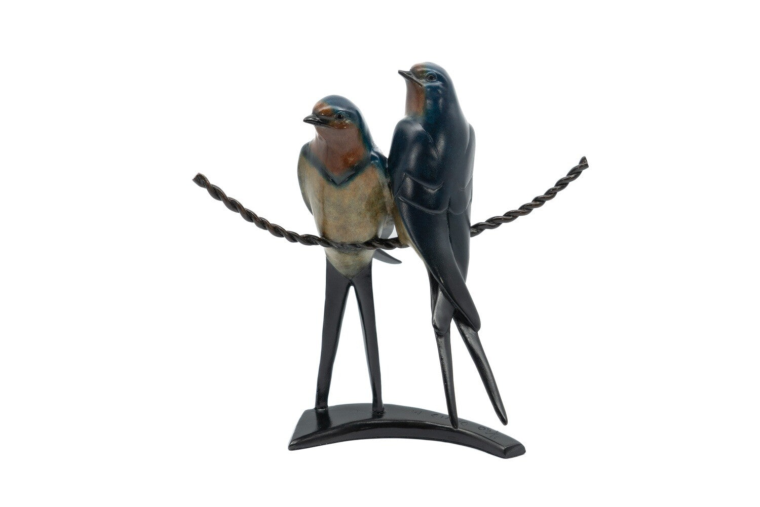 Statue of two birds perched on a branch with a white background