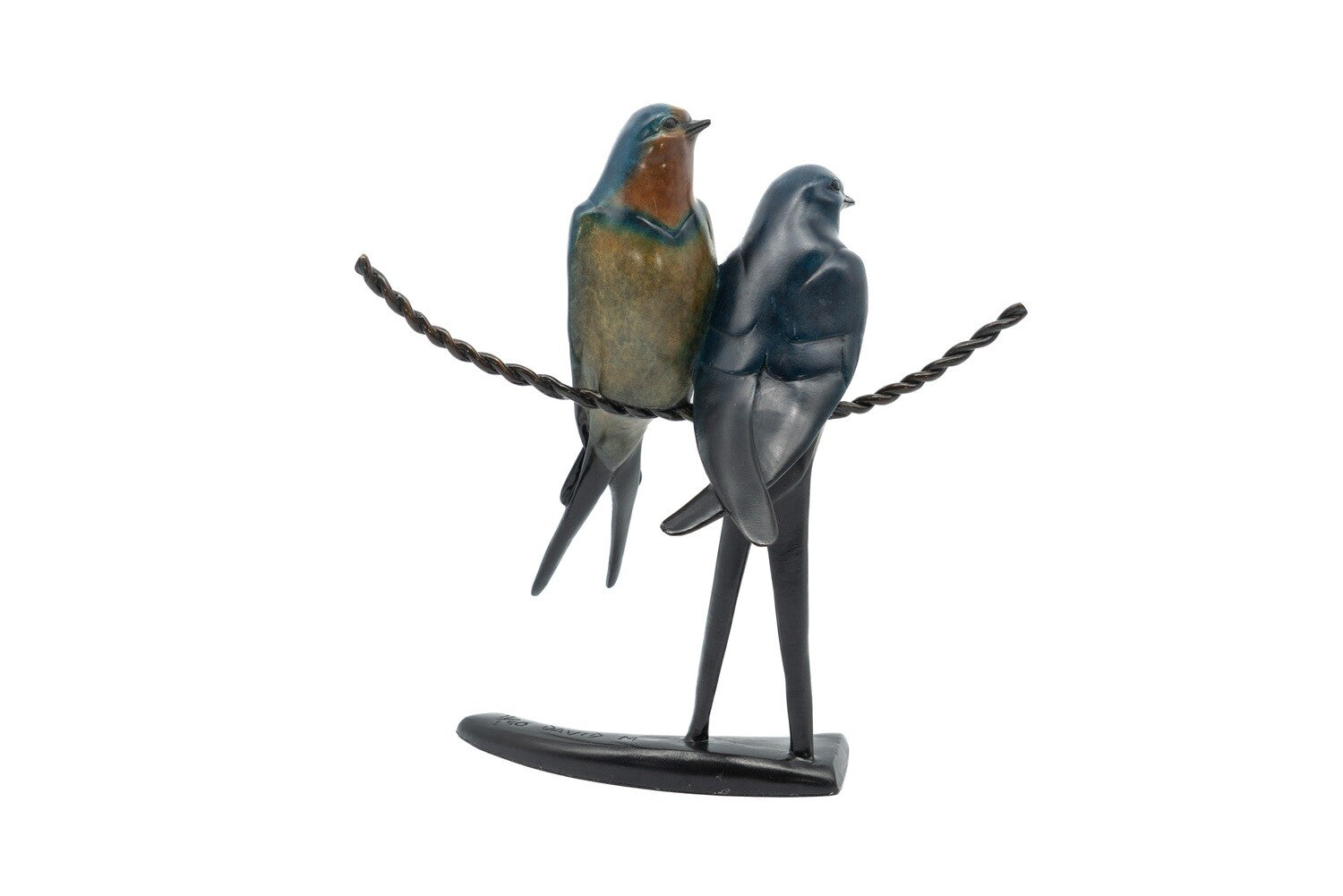 Statue of two birds perched on a branch with a white background