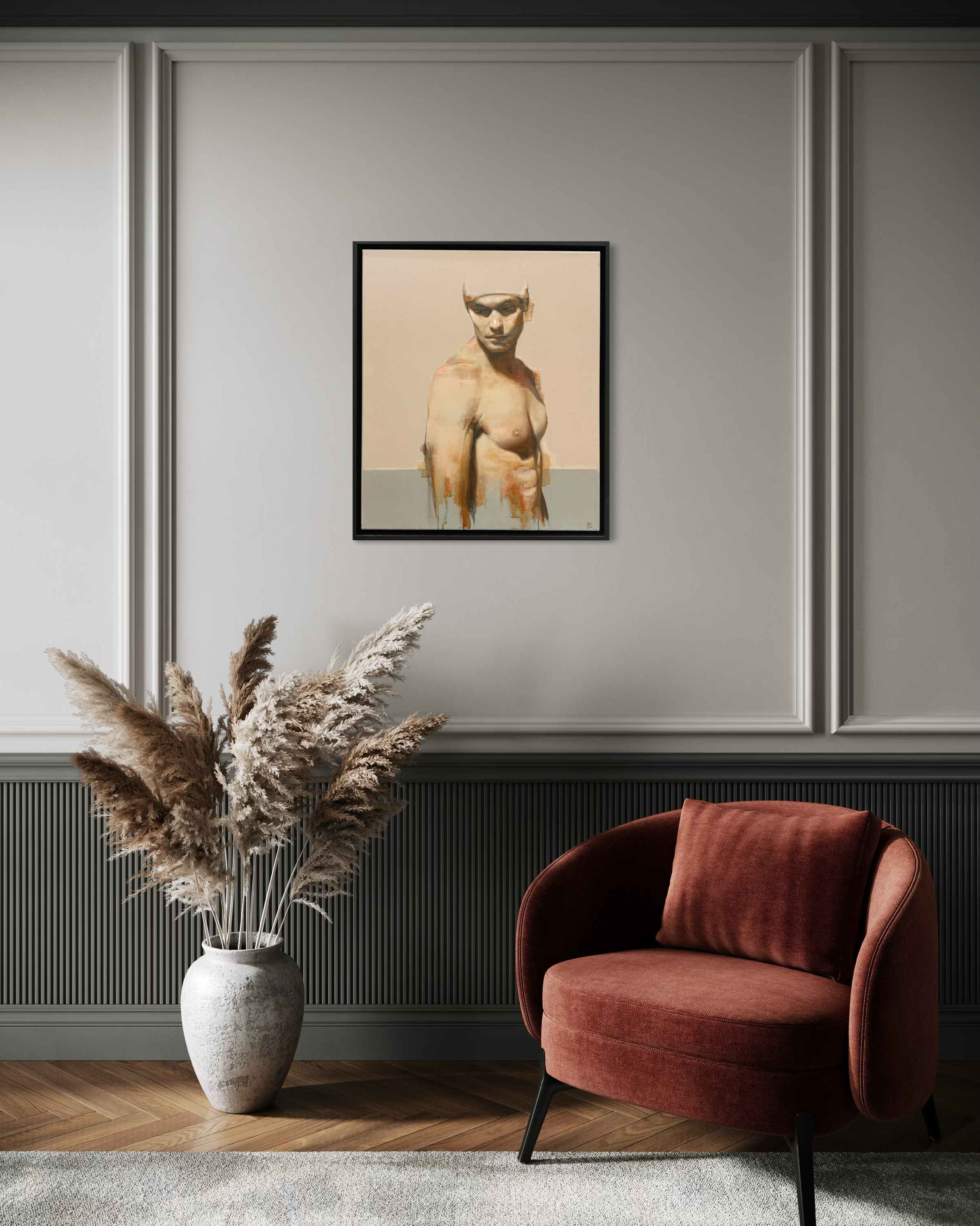 Nude art print on a wall above a modern armchair and vase with dried plants.