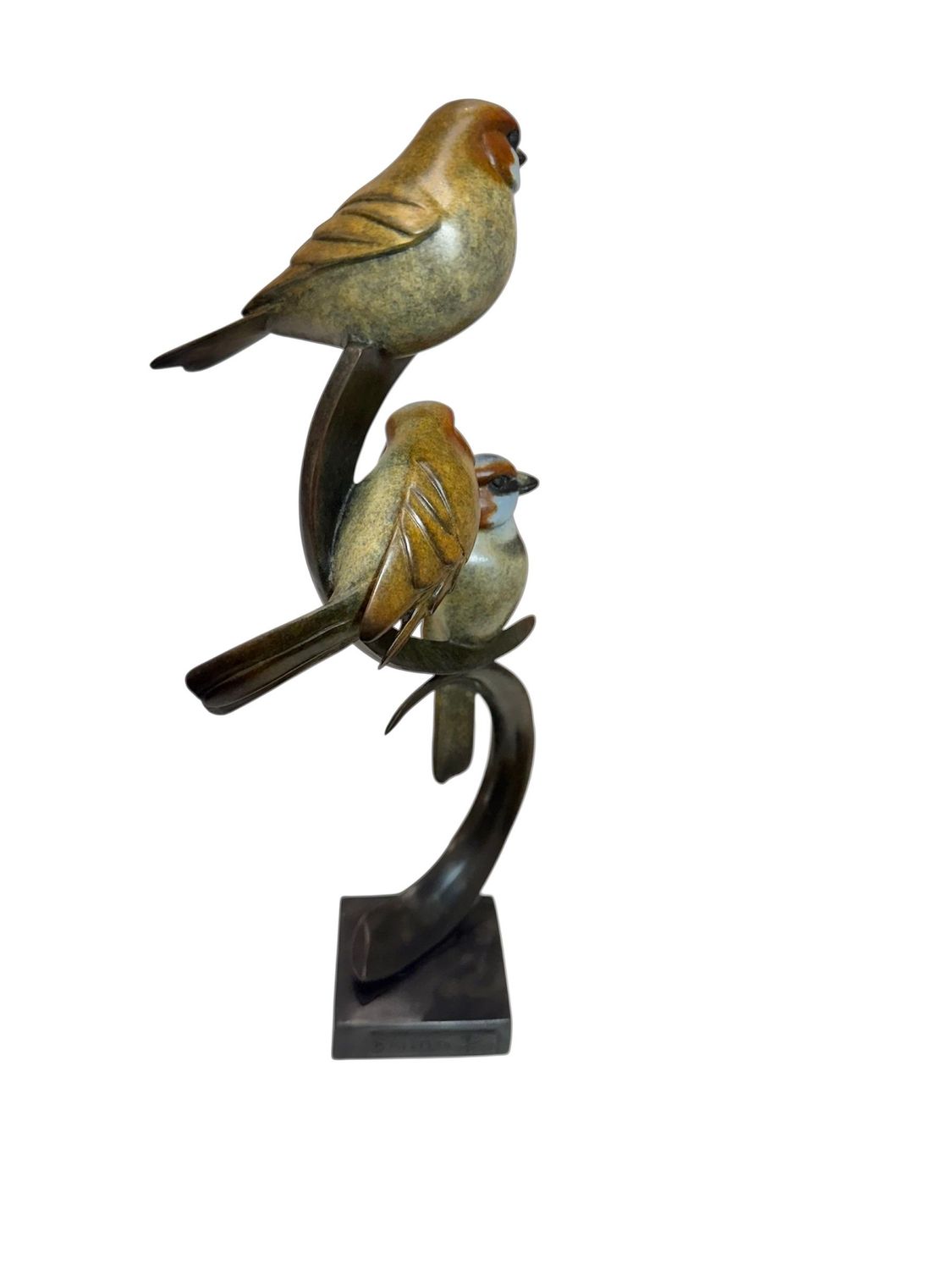 Bronze sculpture of two birds perched on a branch on a white background