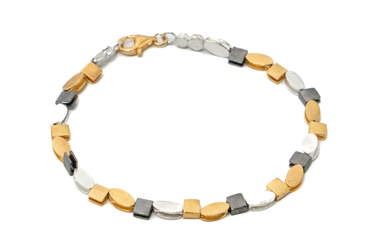 Bracelet with gold, silver, and gray beads on a white background