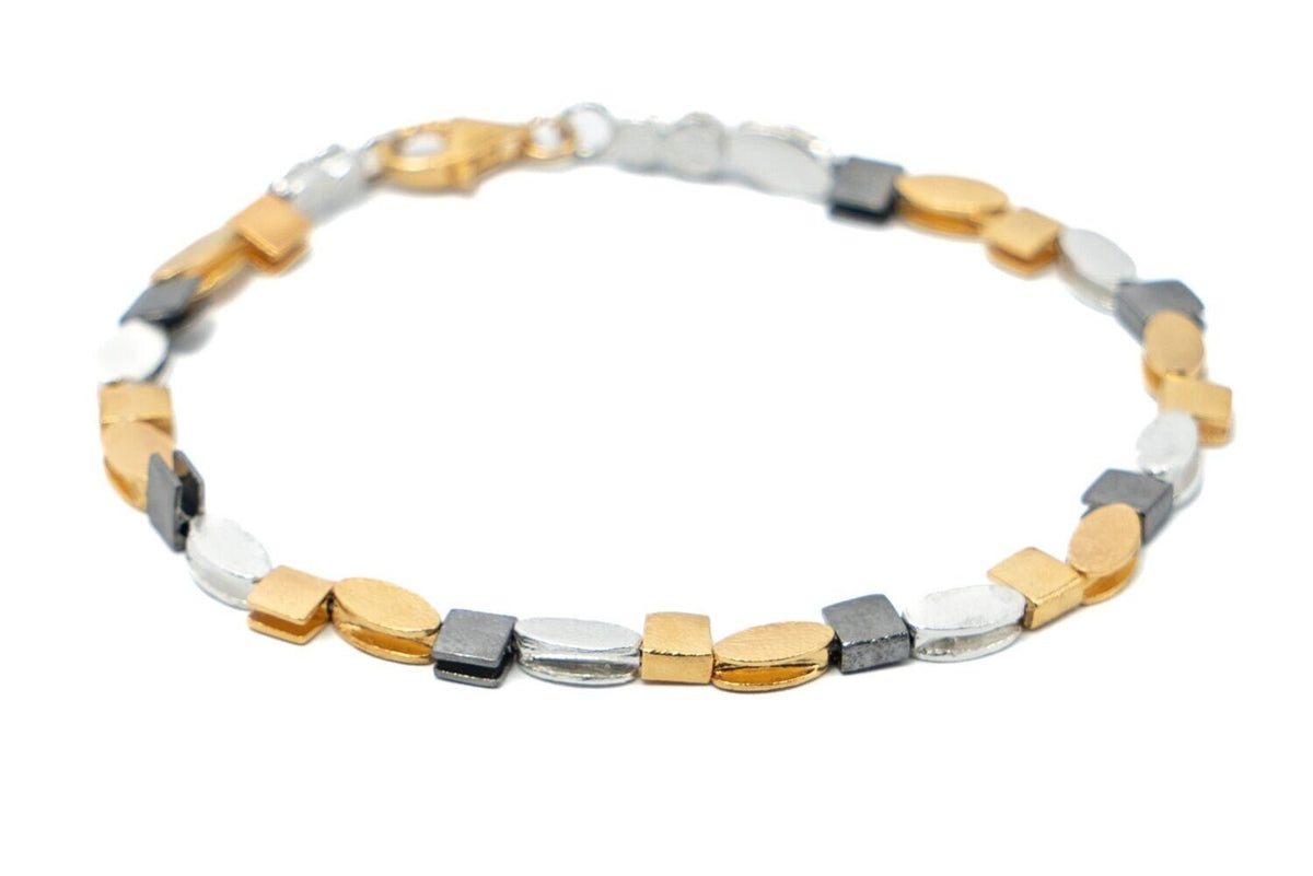 Bracelet with gold, silver, and gray beads on a white background