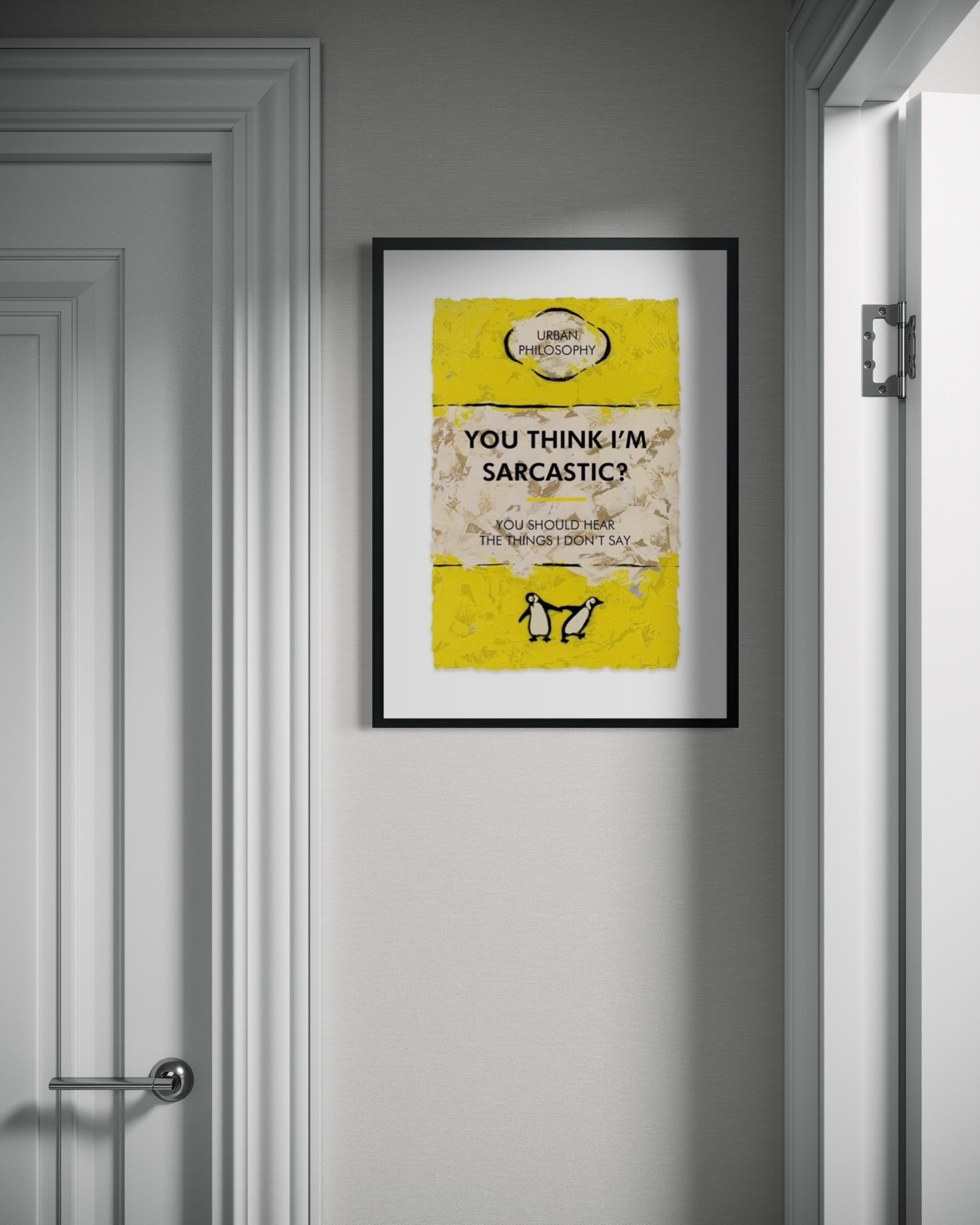 Framed poster with text and a yellow background on a gray wall.