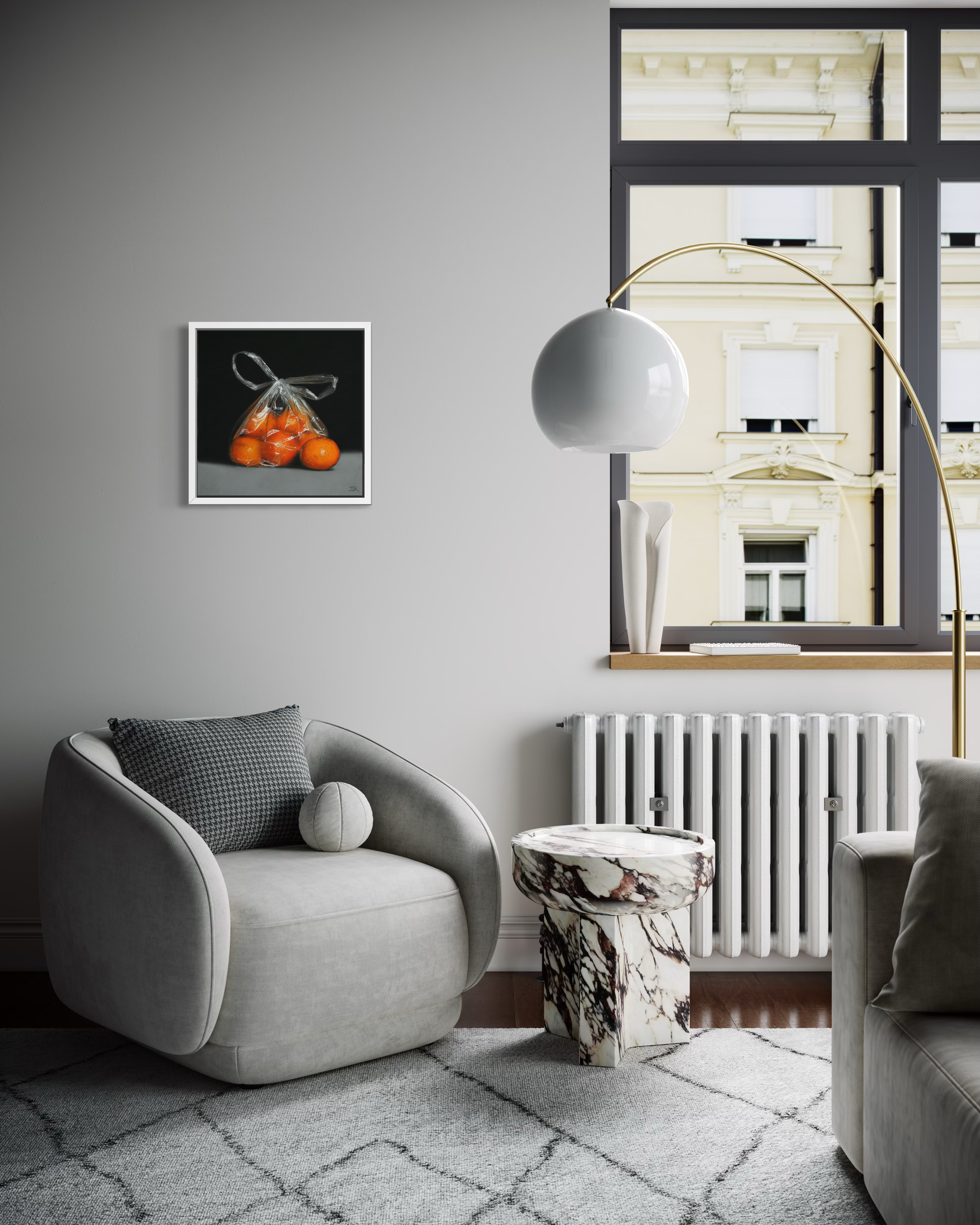 Modern living room with a grey armchair, marble side table, and large mirror with ian rawling original hanging central