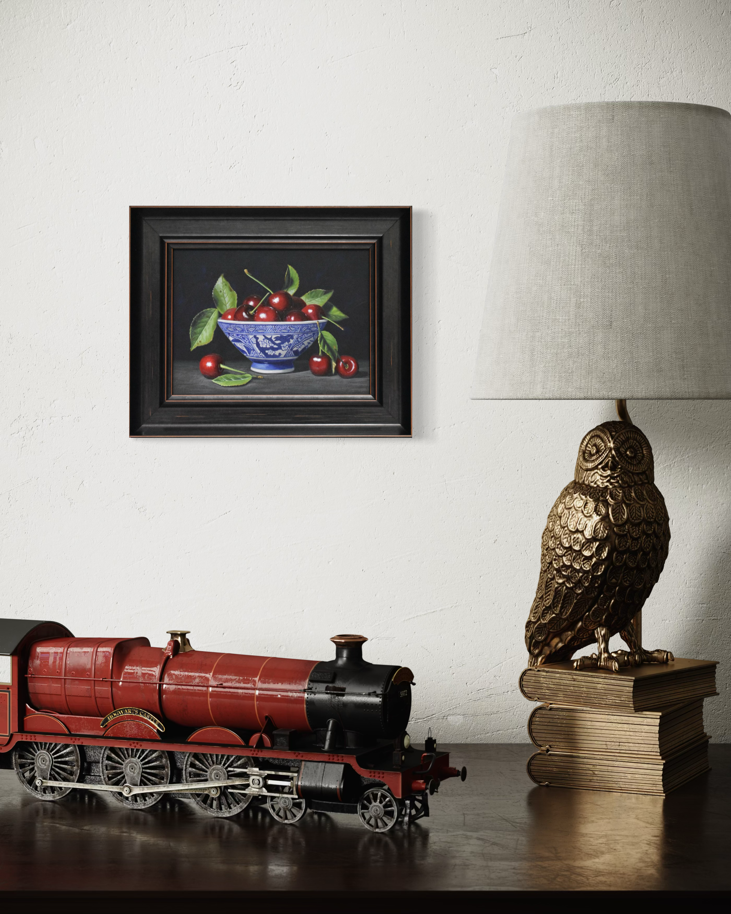 Decorative items including a red toy train, owl lamp, and framed artwork on a shelf.
