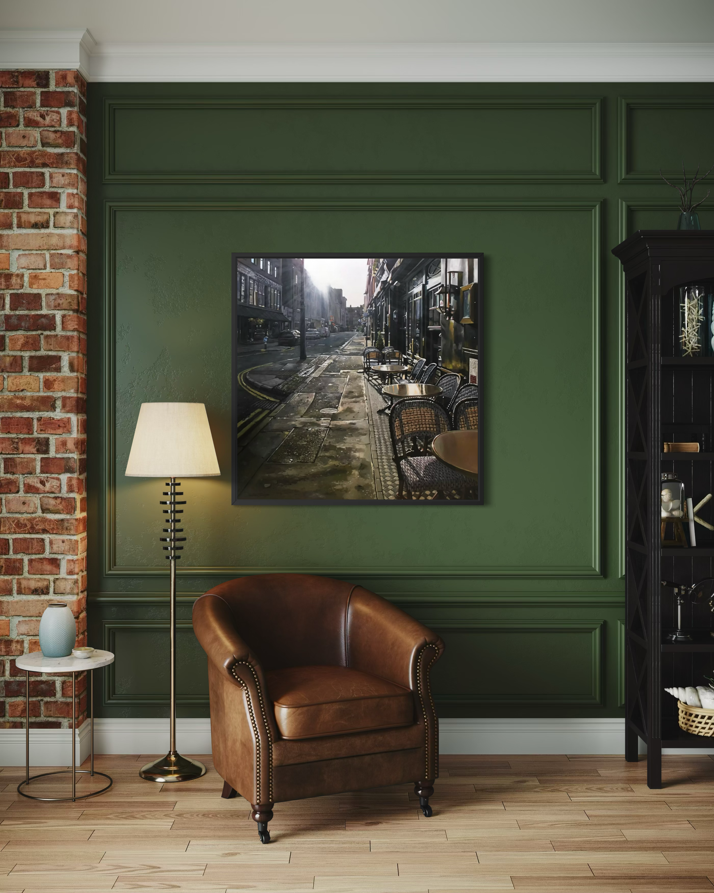 Living room with a brown leather armchair, lamp, and framed original jonathan stewardson on a green wall.