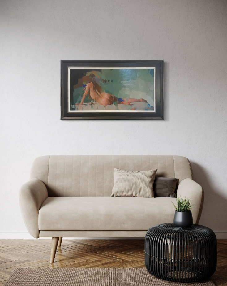 Beige sofa with a black wire side table and a framed figurative painting on a wall.