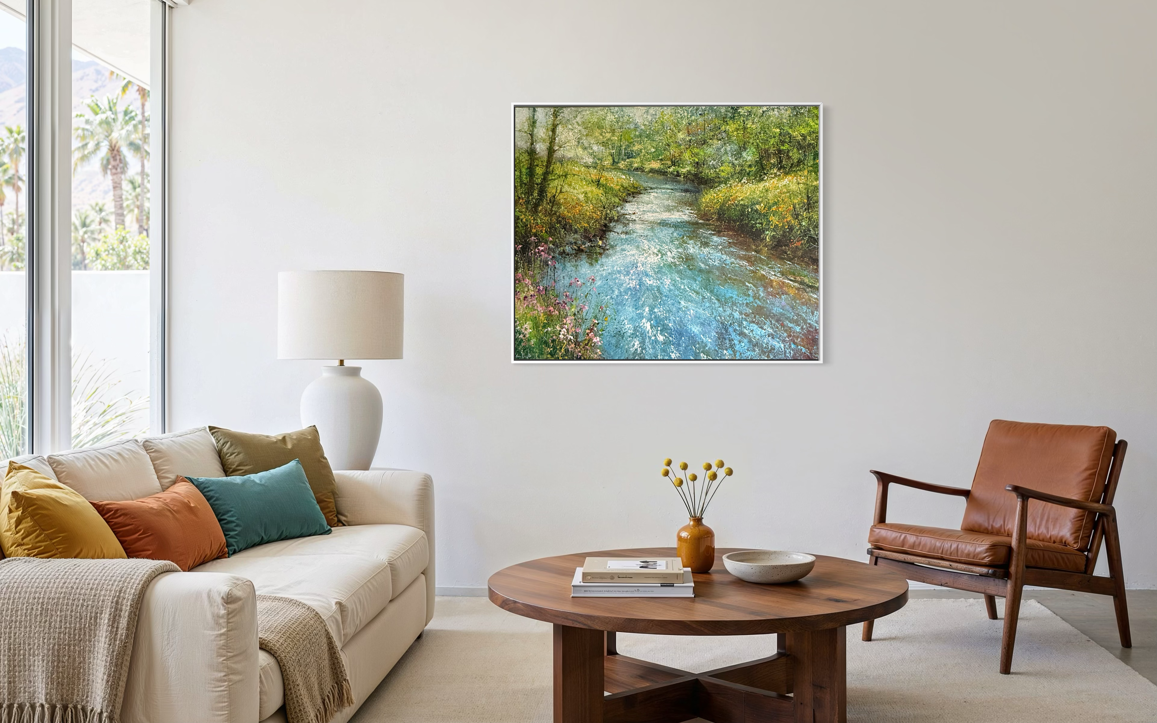 Living room with a painting of a river scene on the wall, a couch, chair, and coffee table.