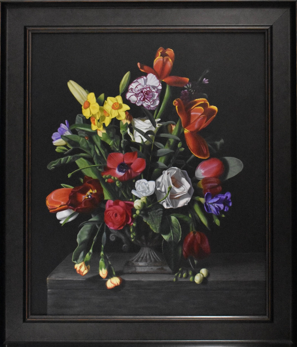 Framed still life painting of a bouquet of flowers on a dark background