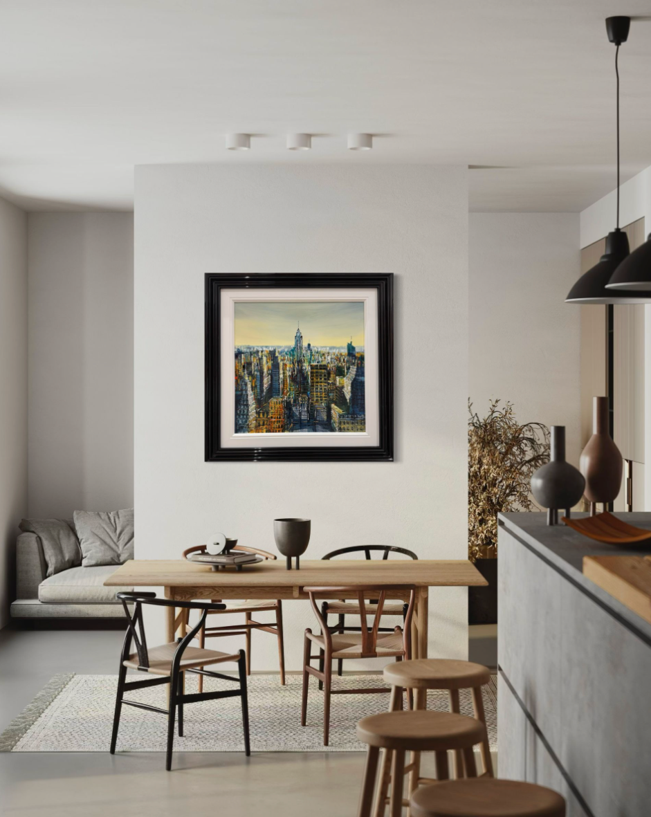 Modern dining area with a framed artwork on the wall, wooden table, and chairs.