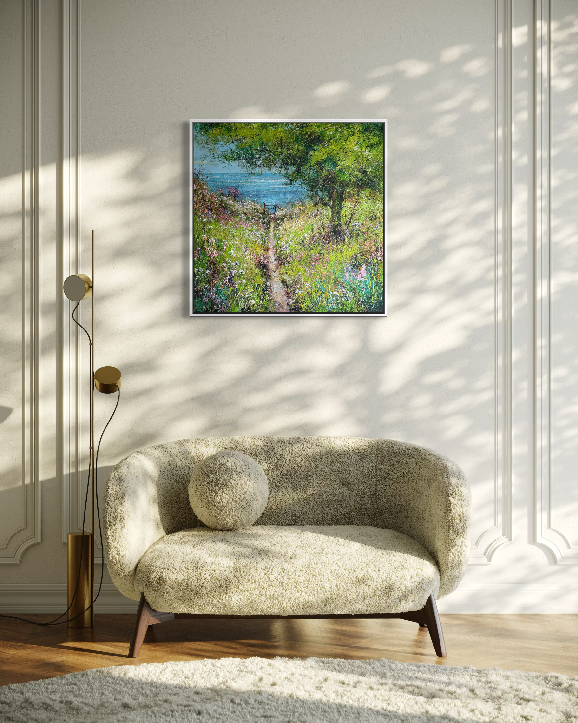Modern living room with a floral-patterned sofa, floor lamp, and framed artwork on the wall.