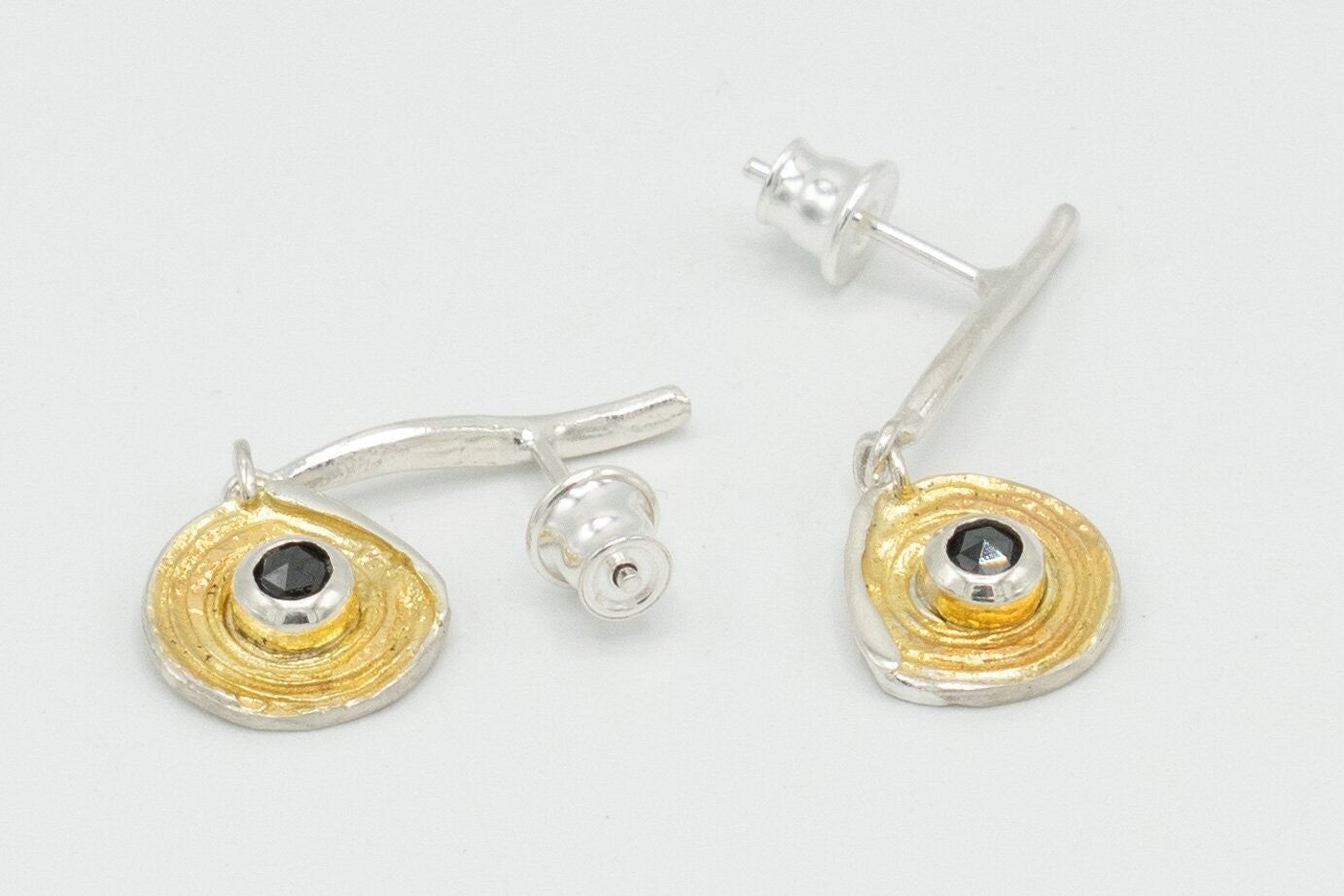 Stylish contemporary Drop earring with black Diamond detail.