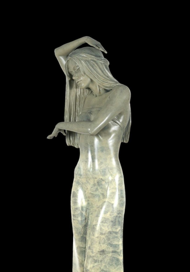 Statue of a woman with long hair against a black background