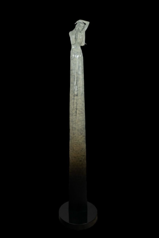 Statue of a woman on a pedestal against a black background
