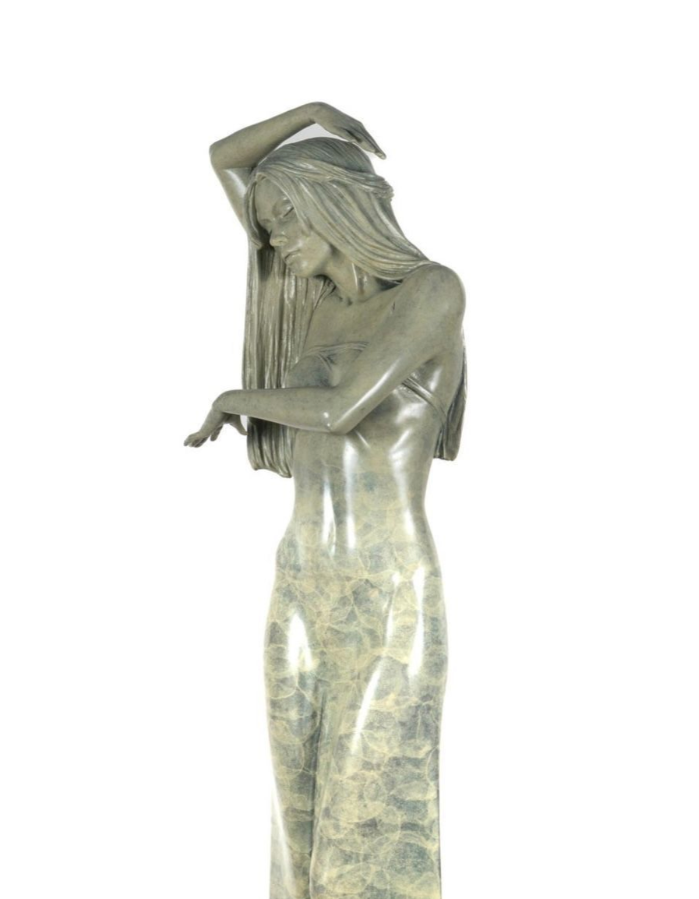 Statue of a woman with long hair and a draped garment on a white background