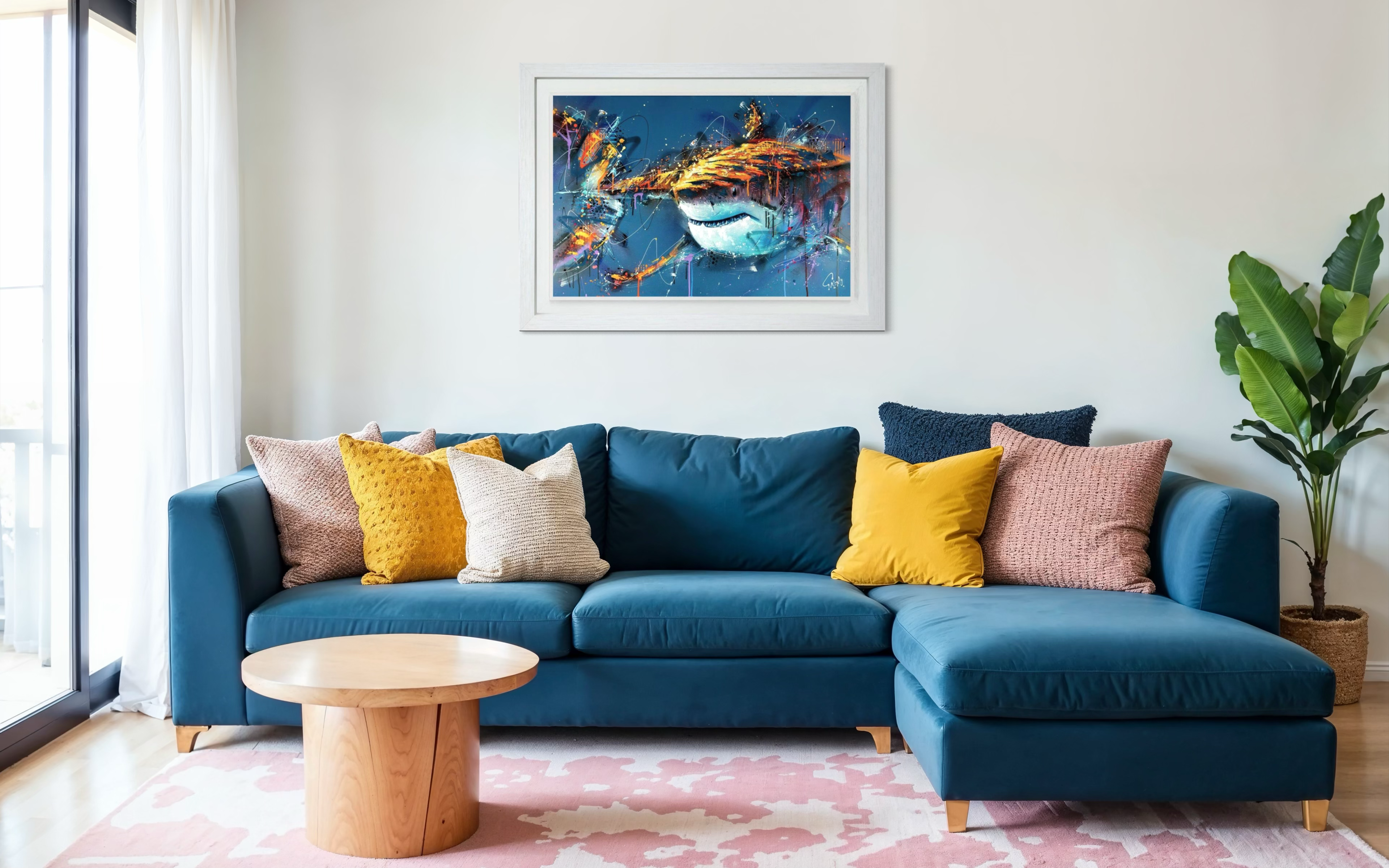 Blue sectional sofa with colorful pillows in a living room setting.