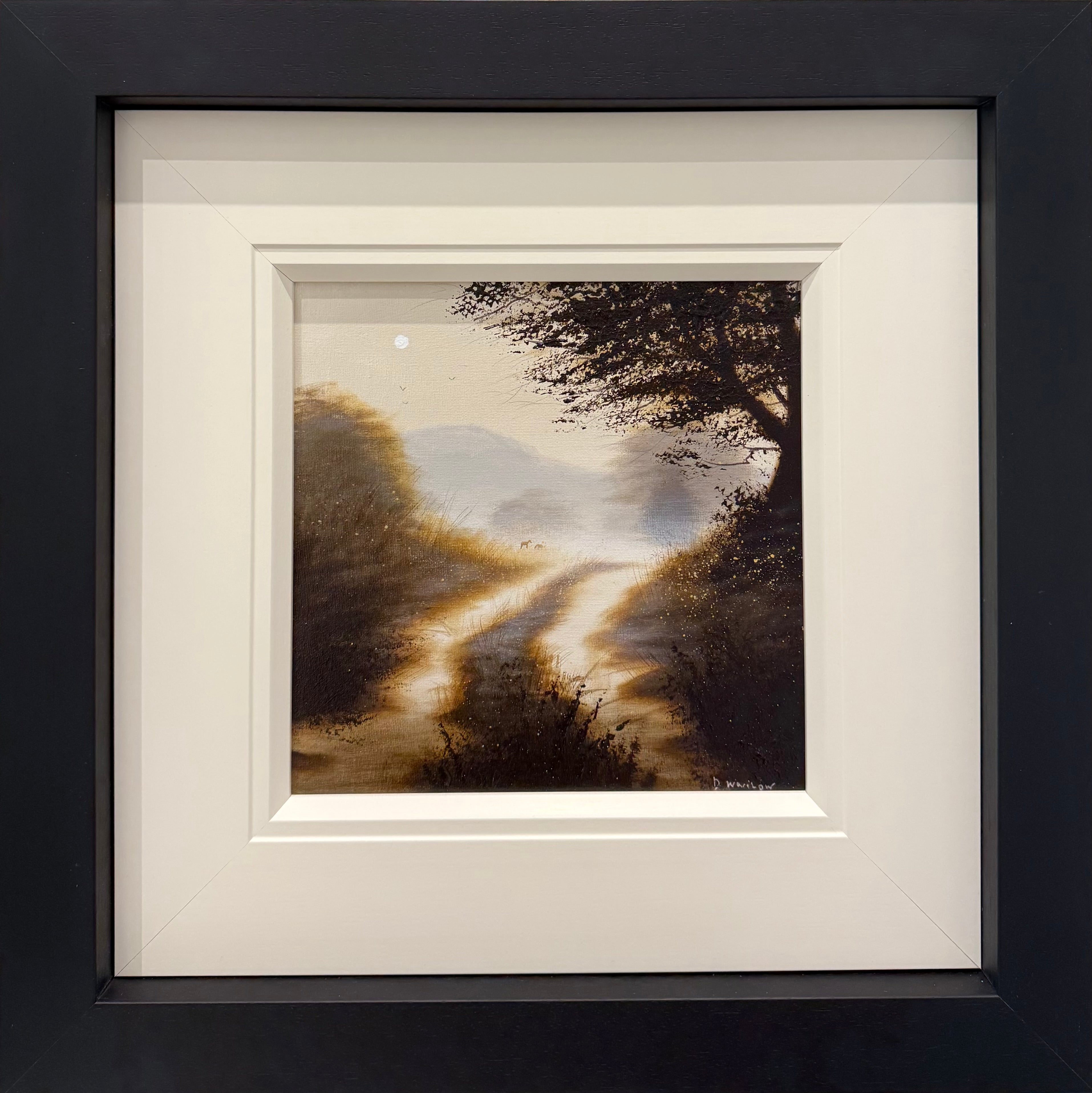 Framed artwork of a landscape with a path and trees on a dark background