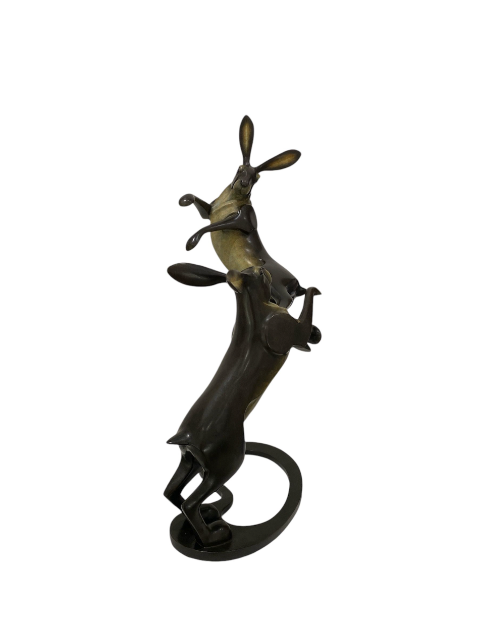 Bronze sculpture of a hare on a white background