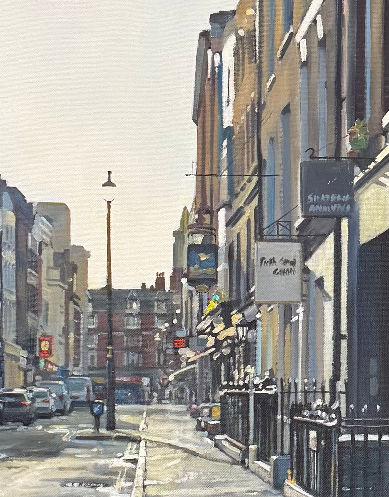 Painting of a London city street in Soho of cars and shops in early sunlight