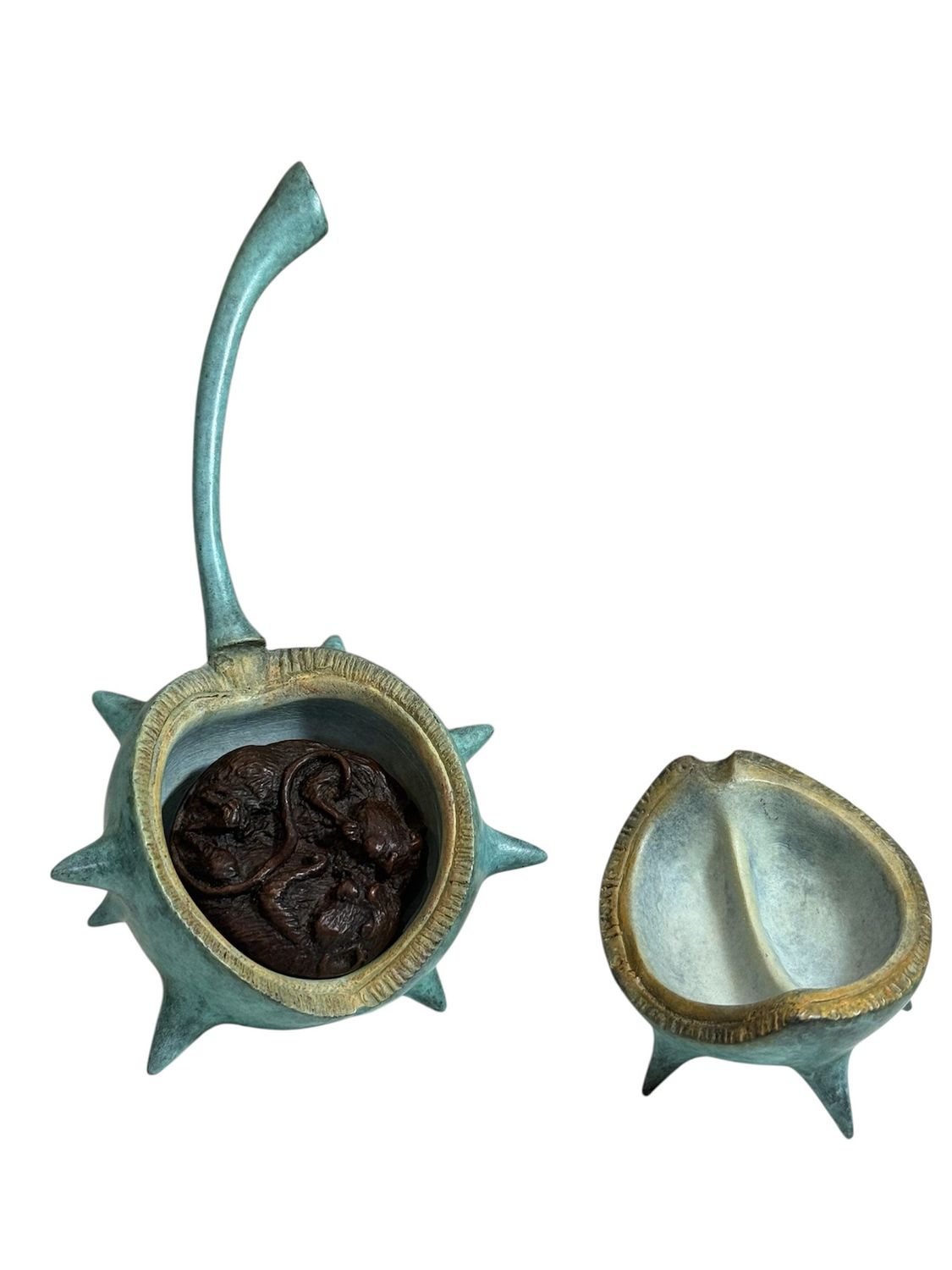 Decorative bronze container with spiky design on a white background