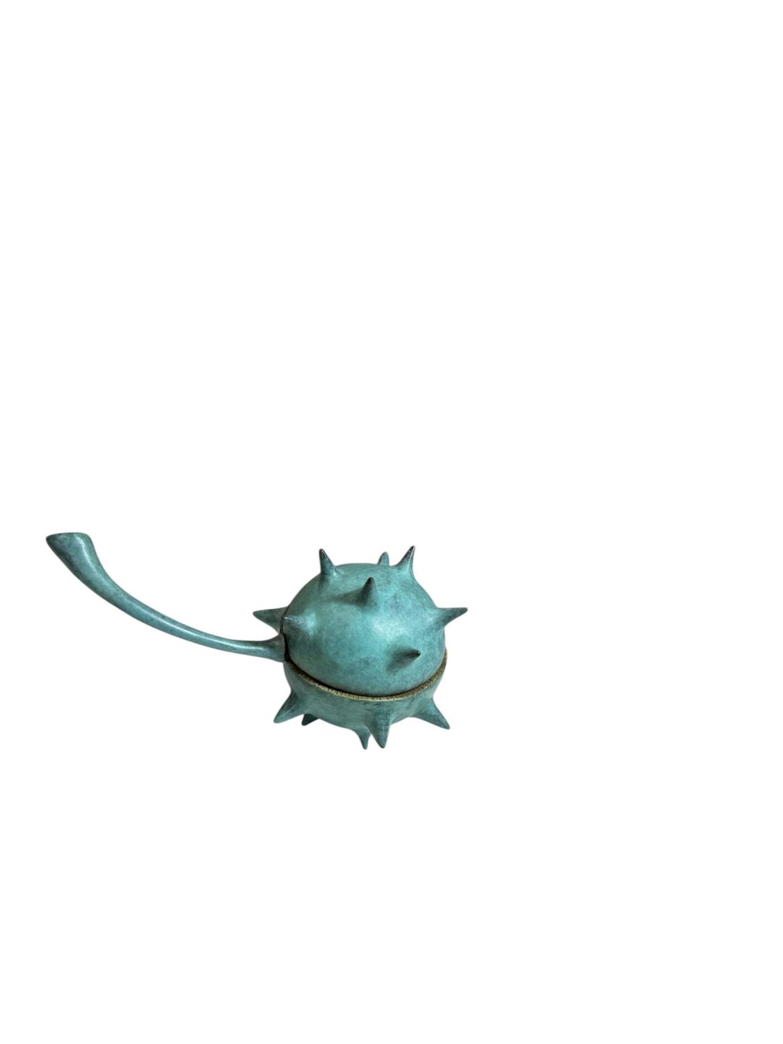Turquoise bronze sculpture with spiky design on a white background