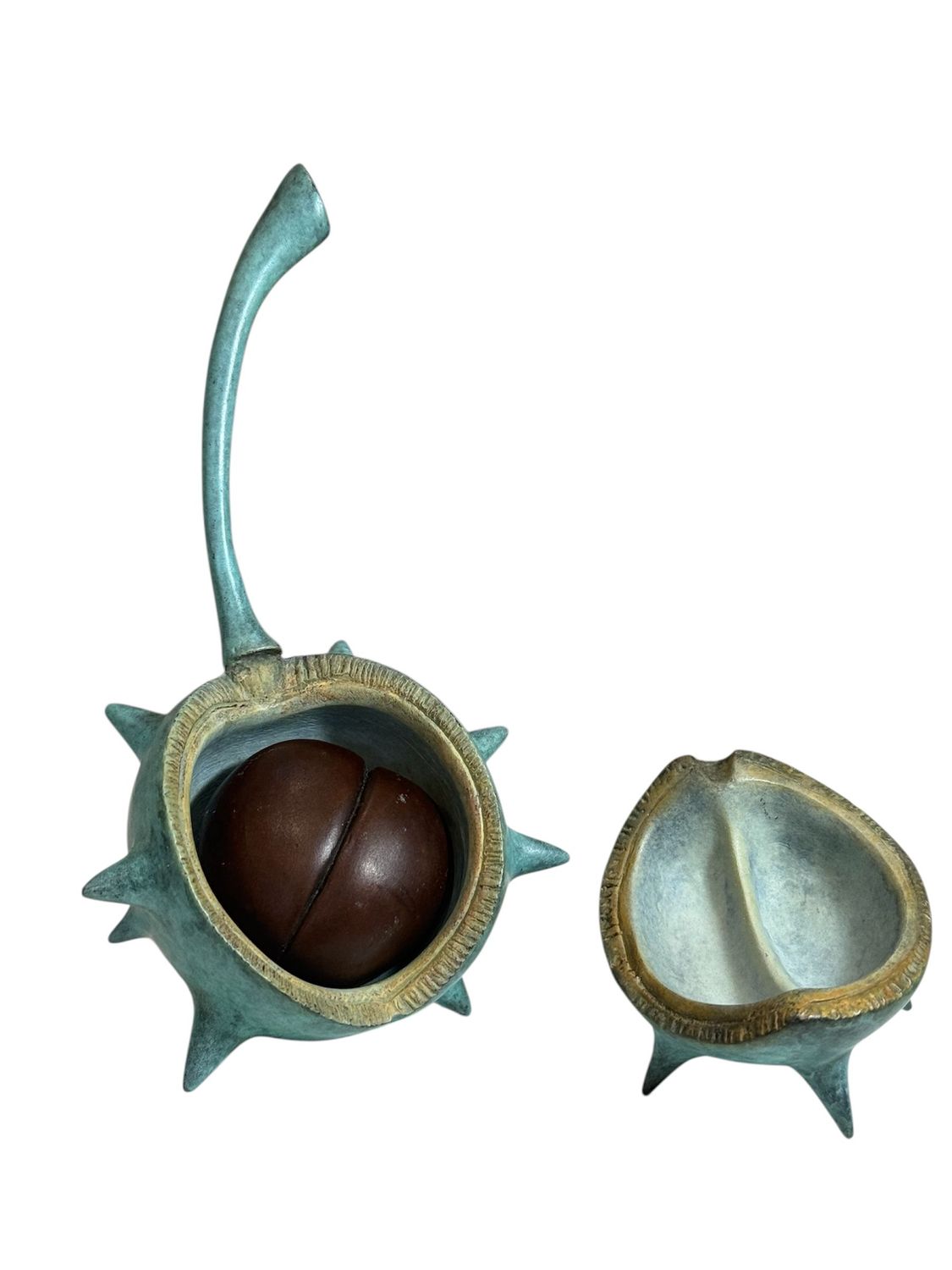 Decorative object resembling a spiky shell with a brown center on a white background