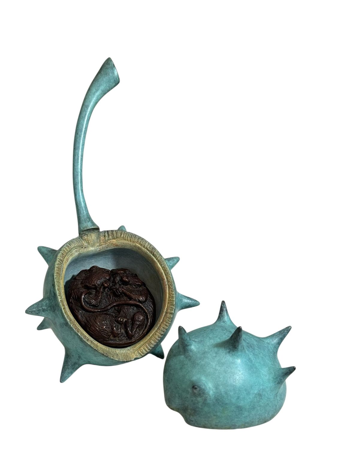 Bronze or copper-colored decorative item with spiky design on a white background