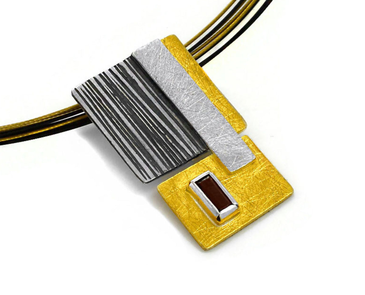 Necklace with a square pendant featuring black, white, and gold colors on a white background