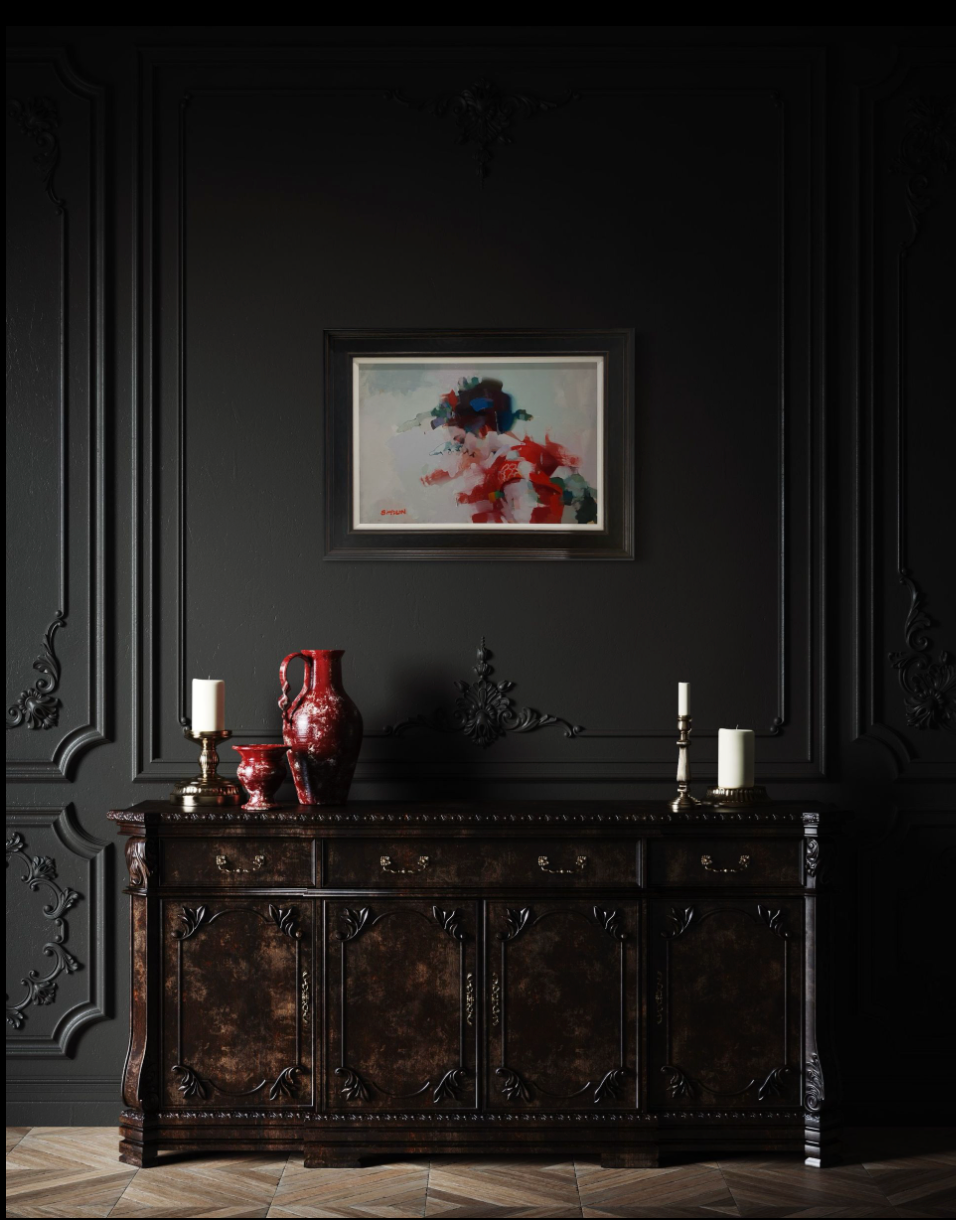 Dark wall with ornate molding, a painting, a dark wooden cabinet with a red vase, and candles.