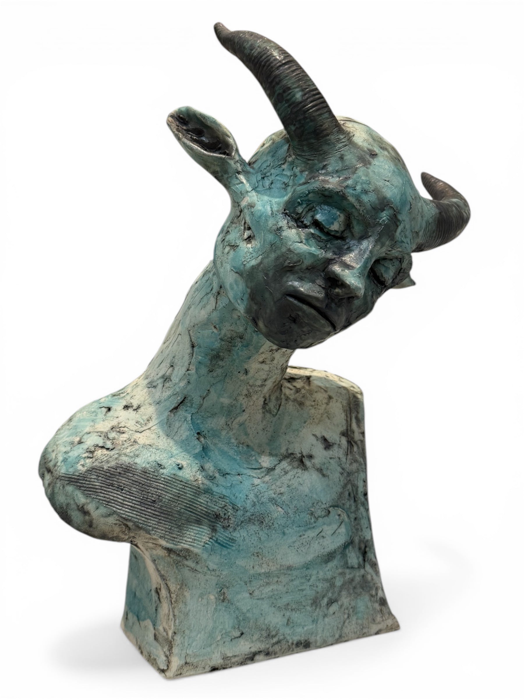 ceramic sculpture of a goat head on a white background