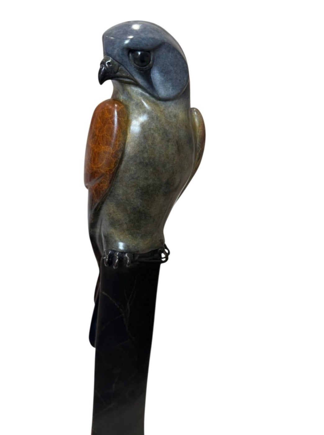 Statue of a kestrel on a white background