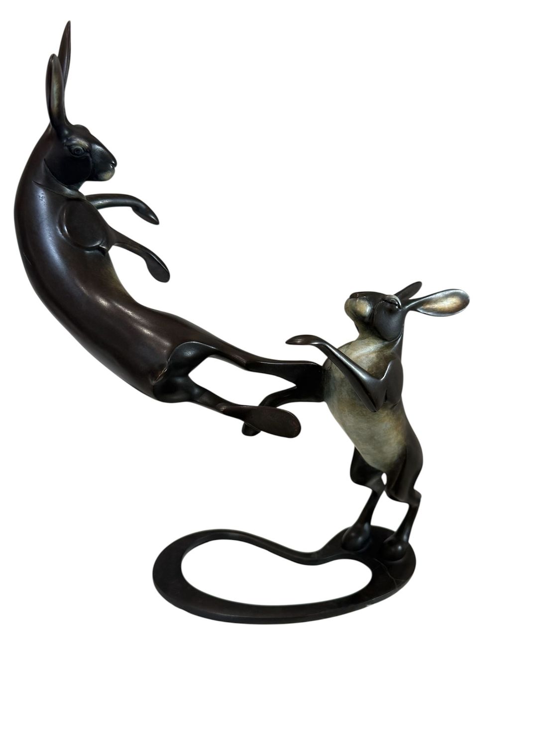 Bronze sculpture of two rabbits in a dynamic pose on a white background