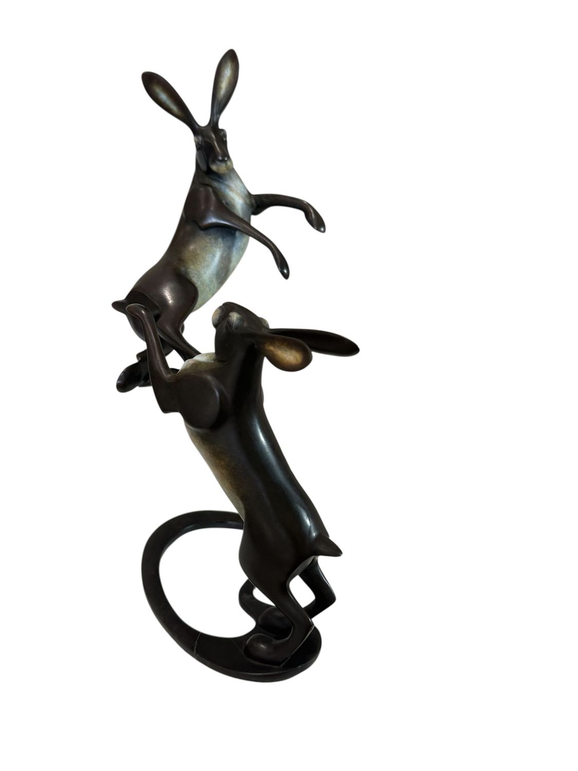 Bronze sculpture of two hares on a white background
