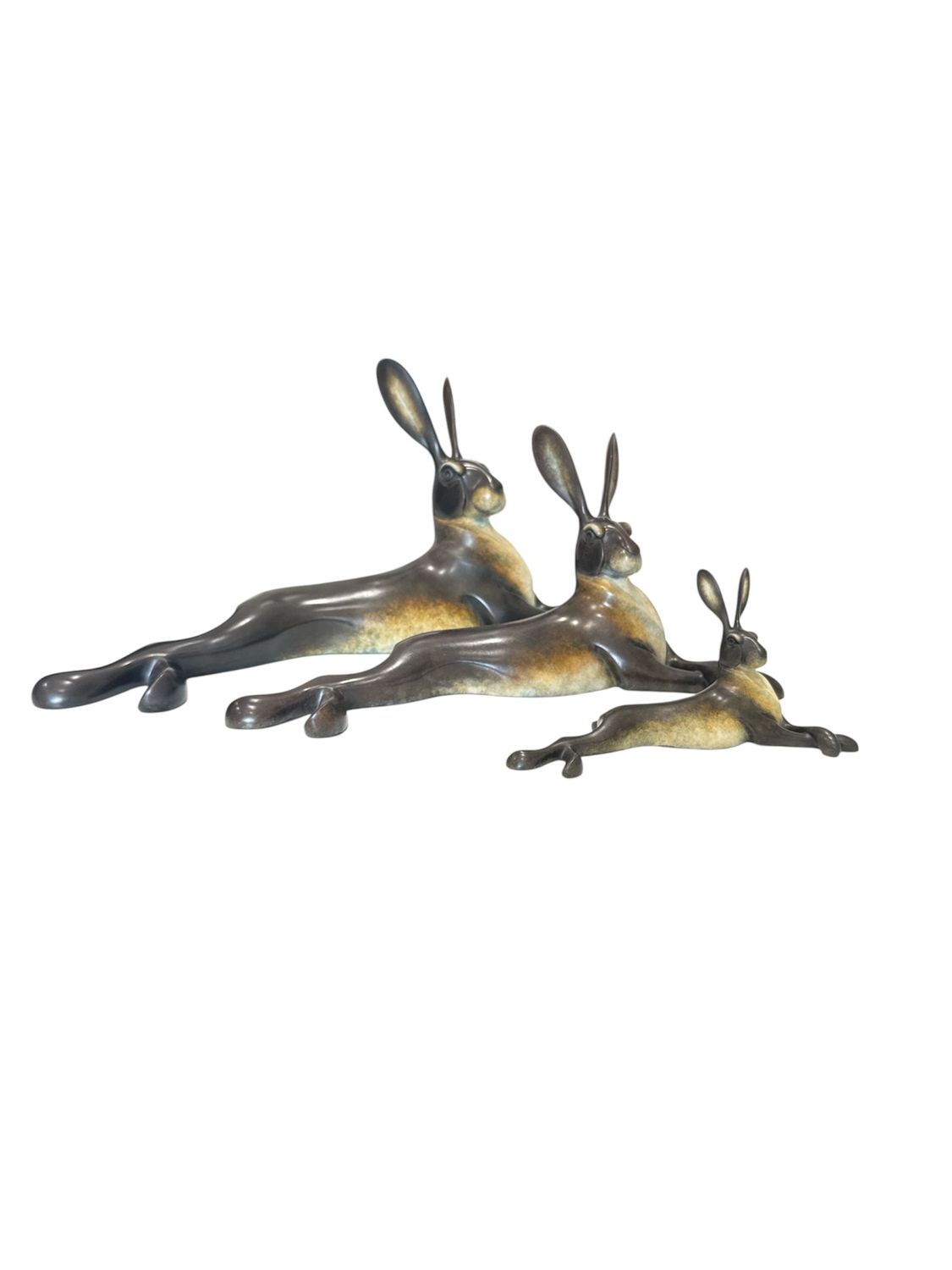 Bronze sculpture of three rabbits on a white background