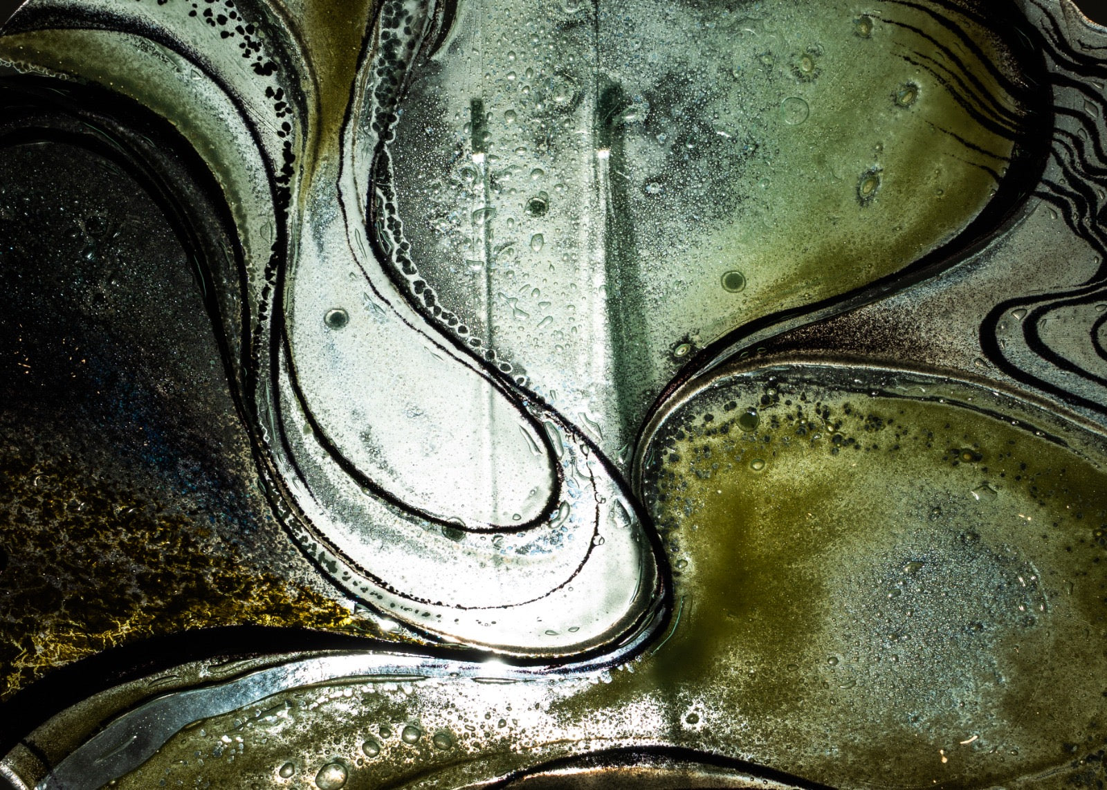 Close-up of swirling patterns in a metallic or ceramic surface