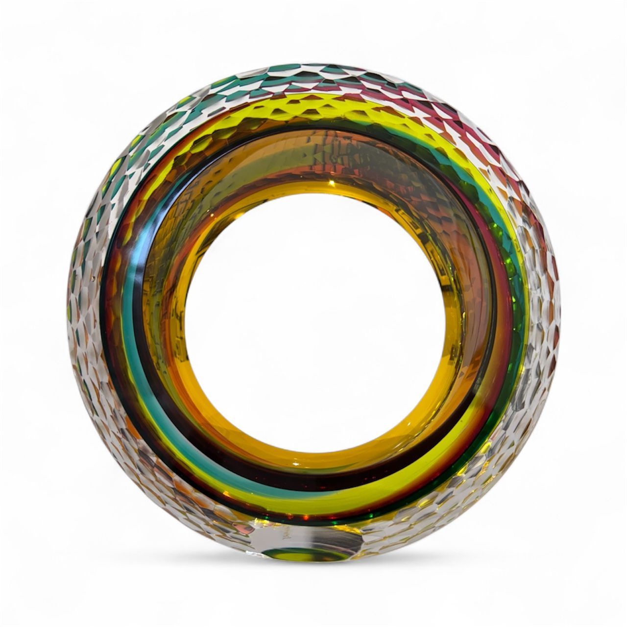 Multicolored glass ring with textured surface on a white background