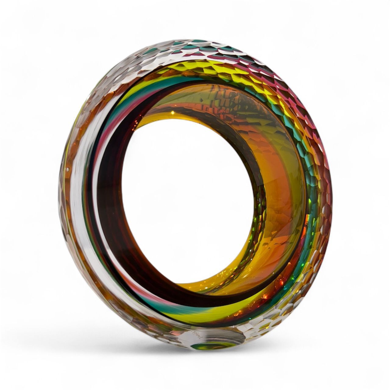 Multicolored glass ring on a white background