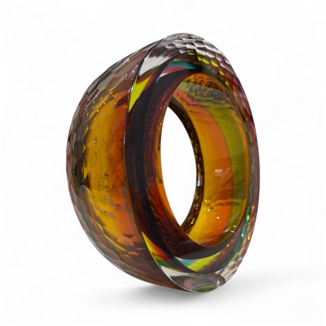 Multicolored glass ring on a white background