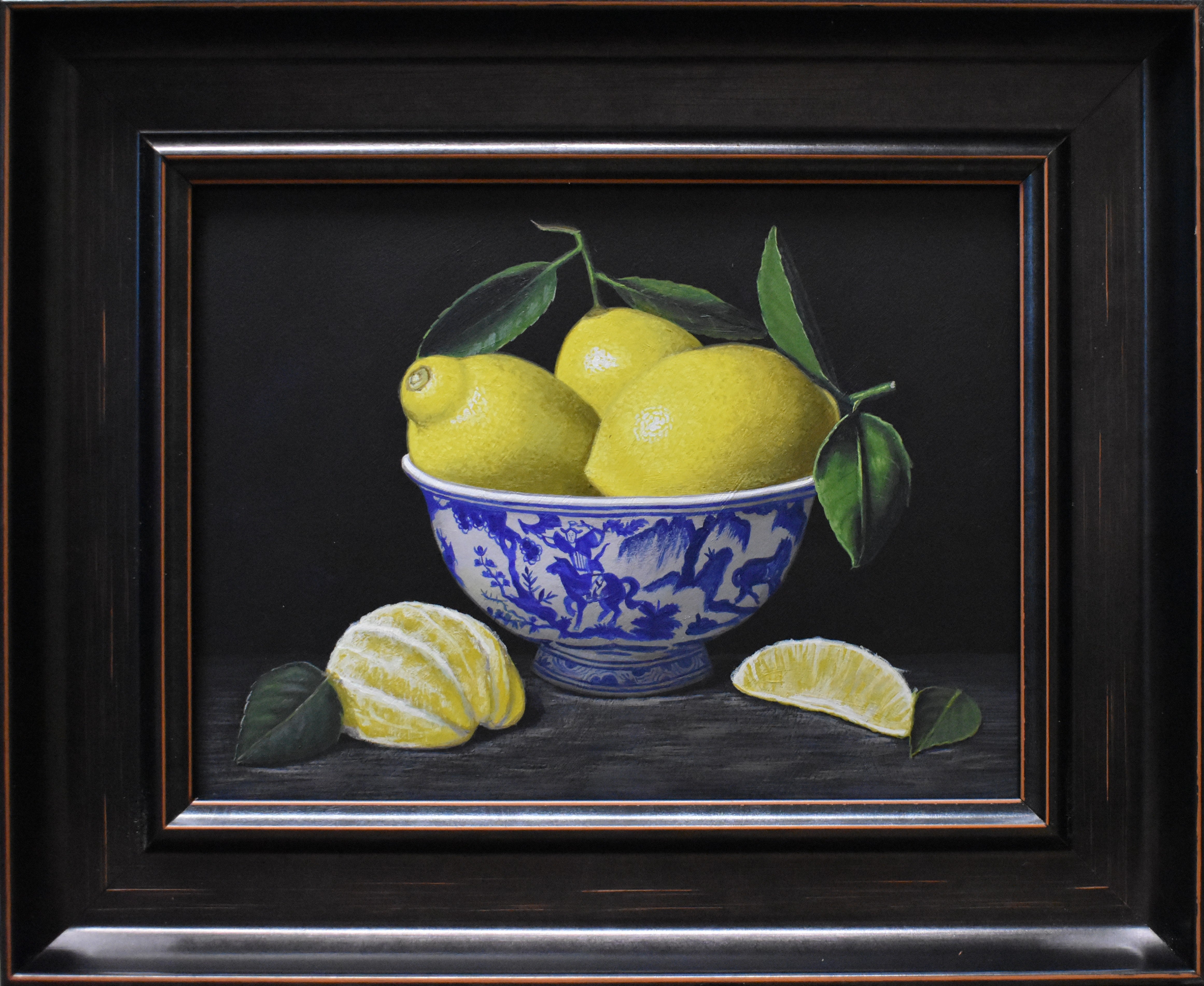Framed artwork of lemons in a blue and white bowl on a dark background