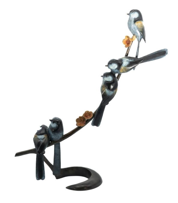 Decorative metal sculpture of birds on a branch with flowers on a white background