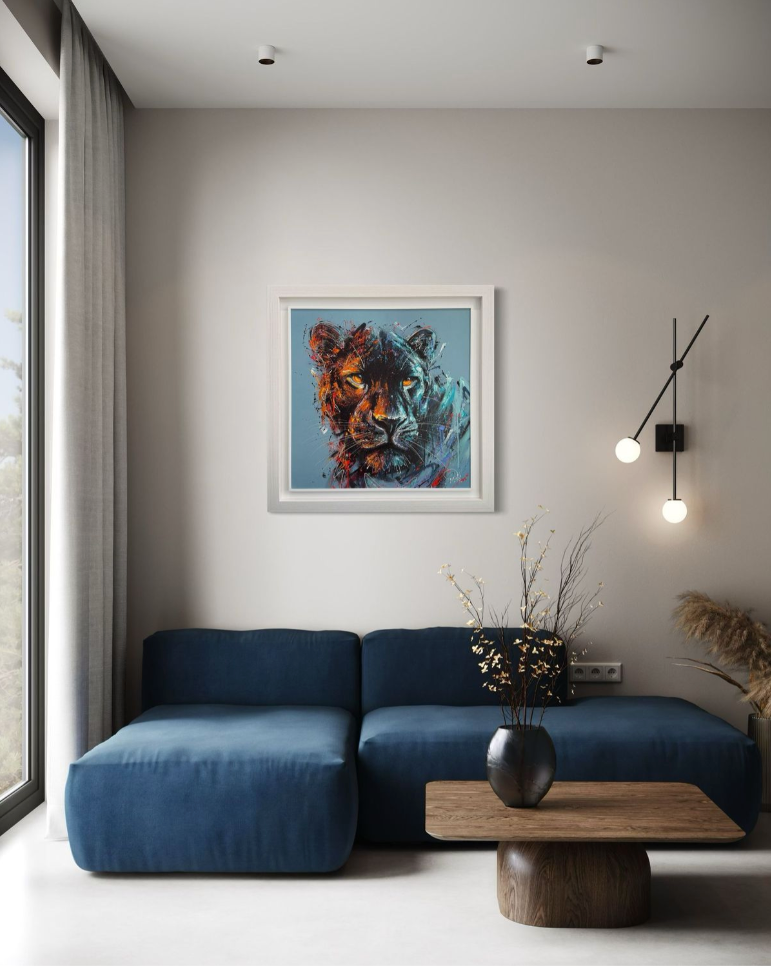 Modern living room with a blue sofa, wooden coffee table, and wall art of a tiger.