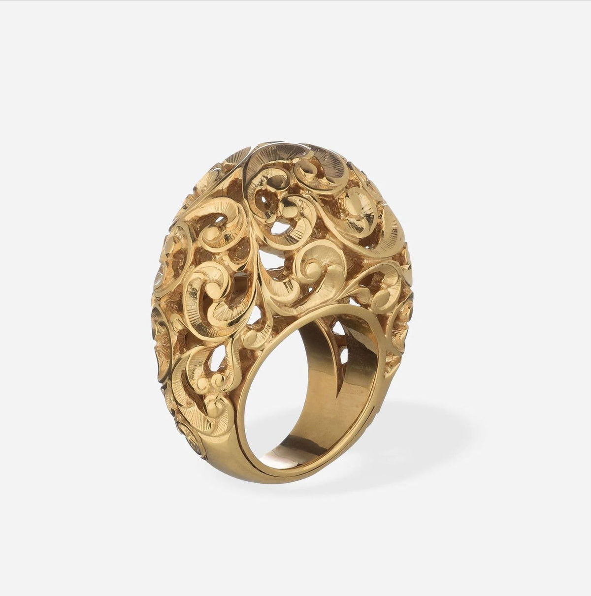 Gold ring with intricate filigree design on a white background