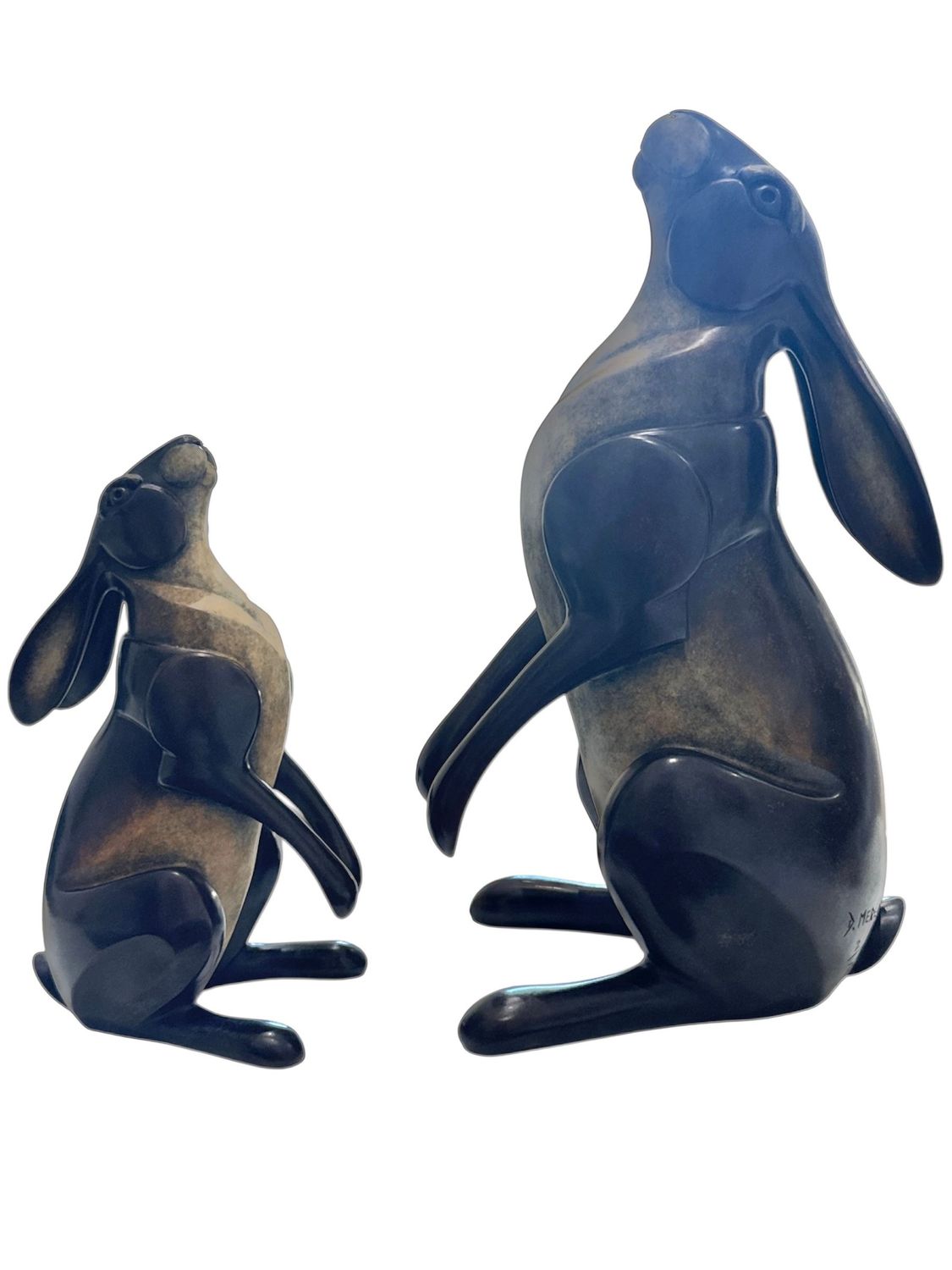 Two ceramic rabbit figurines on a white background