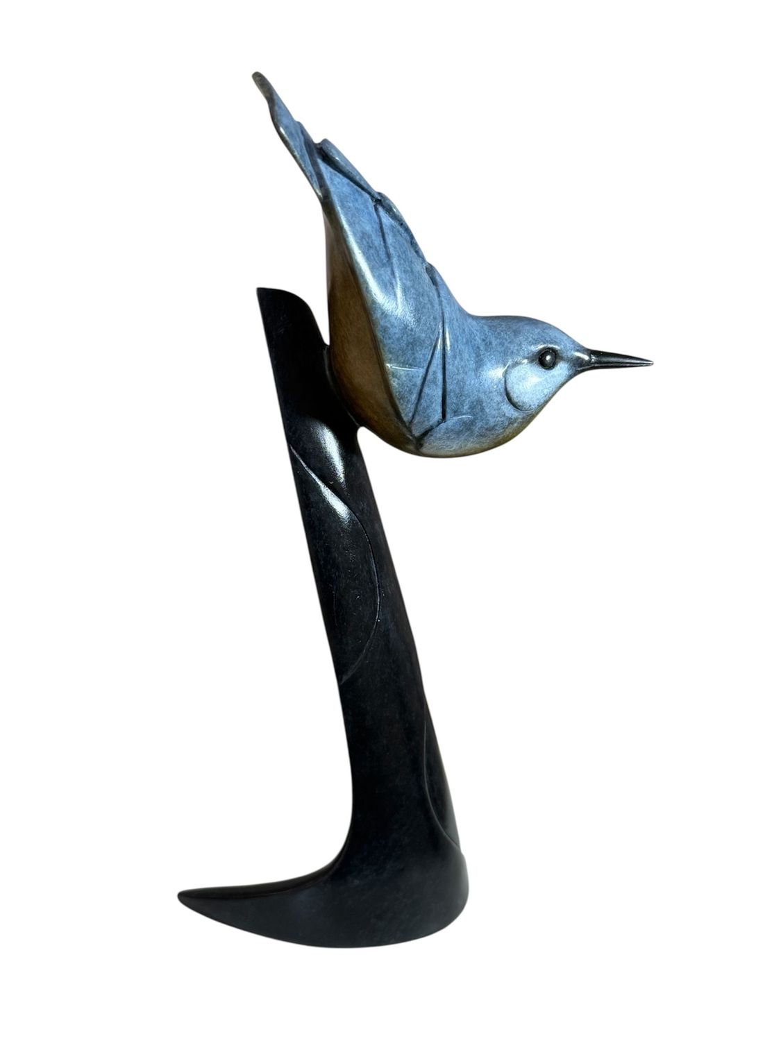 Blue bird figurine perched on a black stand against a white background