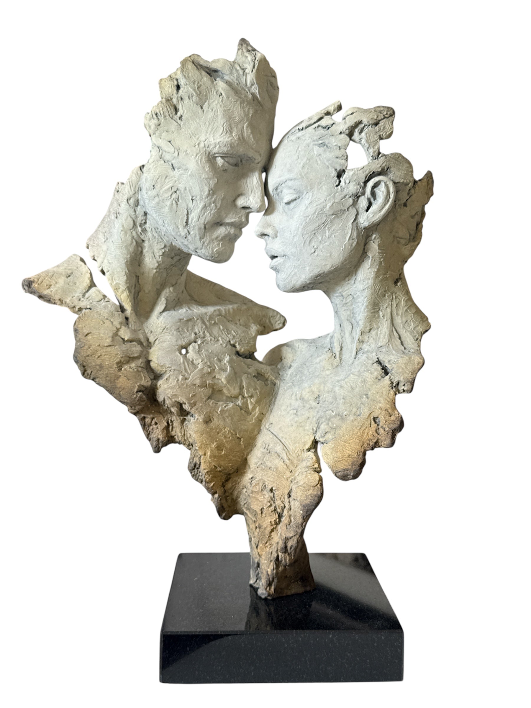 Abstract sculpture of two faces on a white background