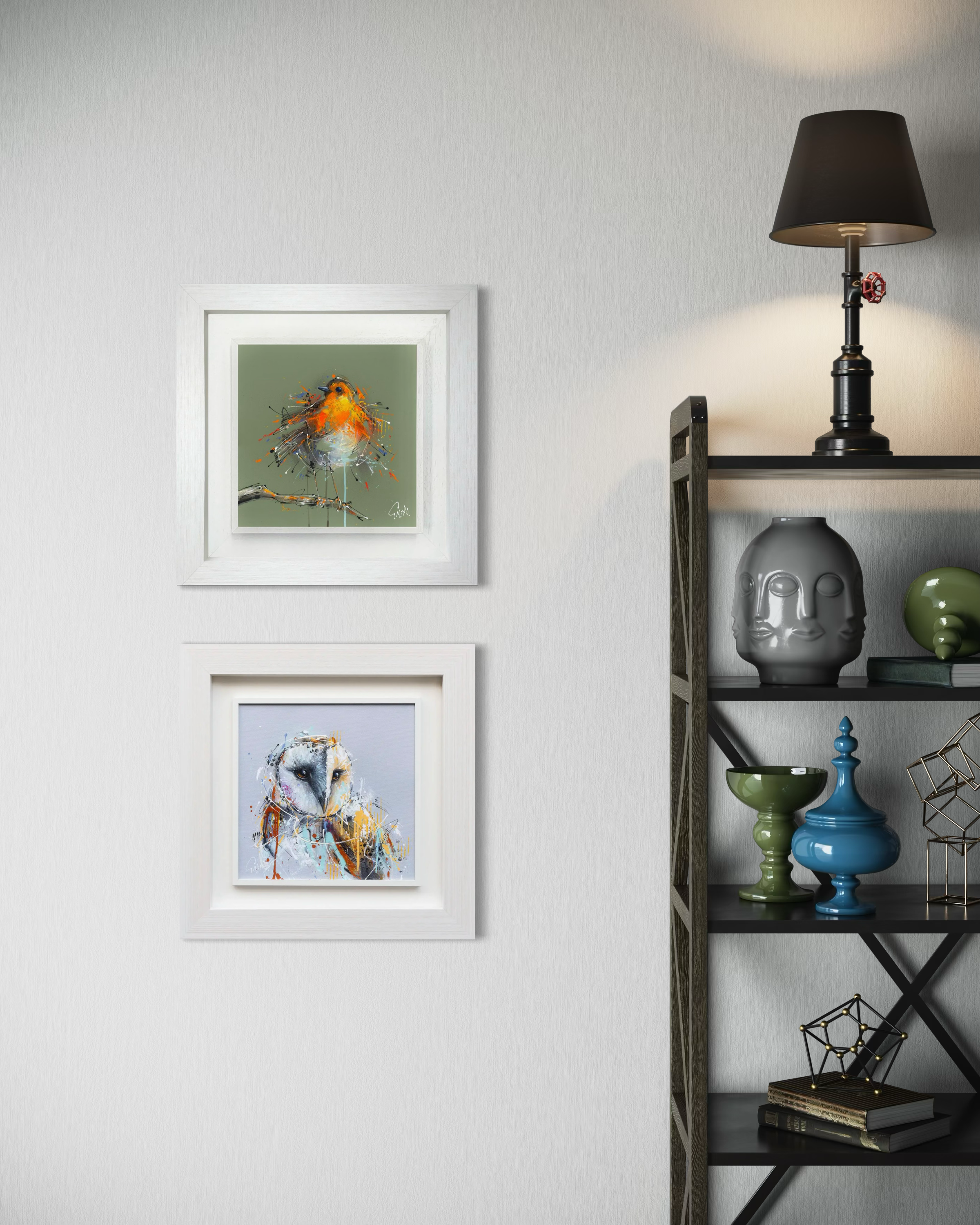 Framed artwork of a robin and owl on a wall above a shelf with decorative items.