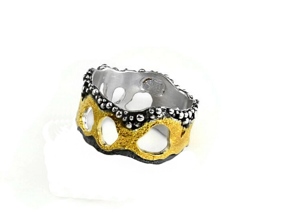 Ring with gold and silver design on a white background