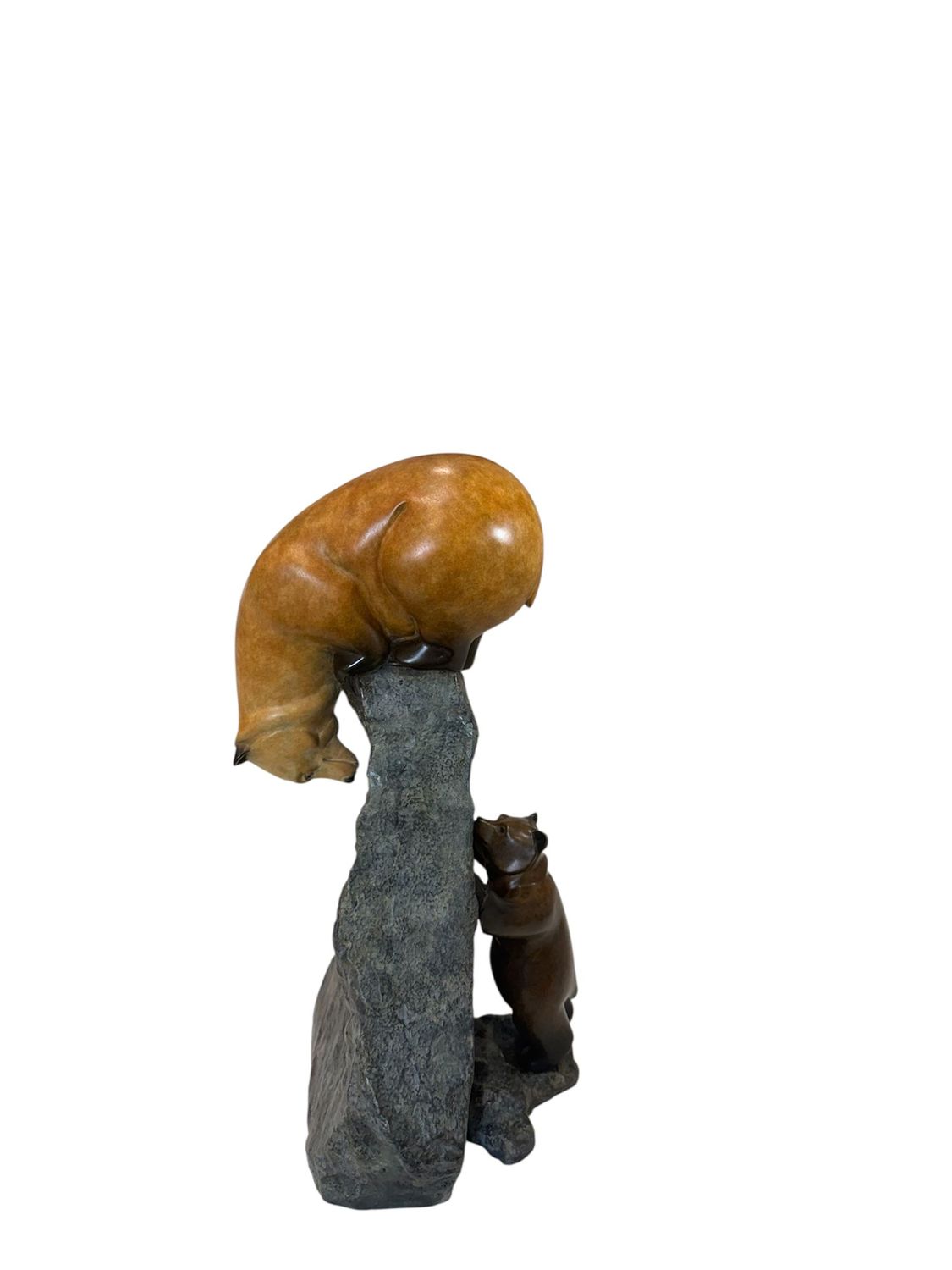 Decorative sculpture of a bear on a rock with a cub underneath on a white background
