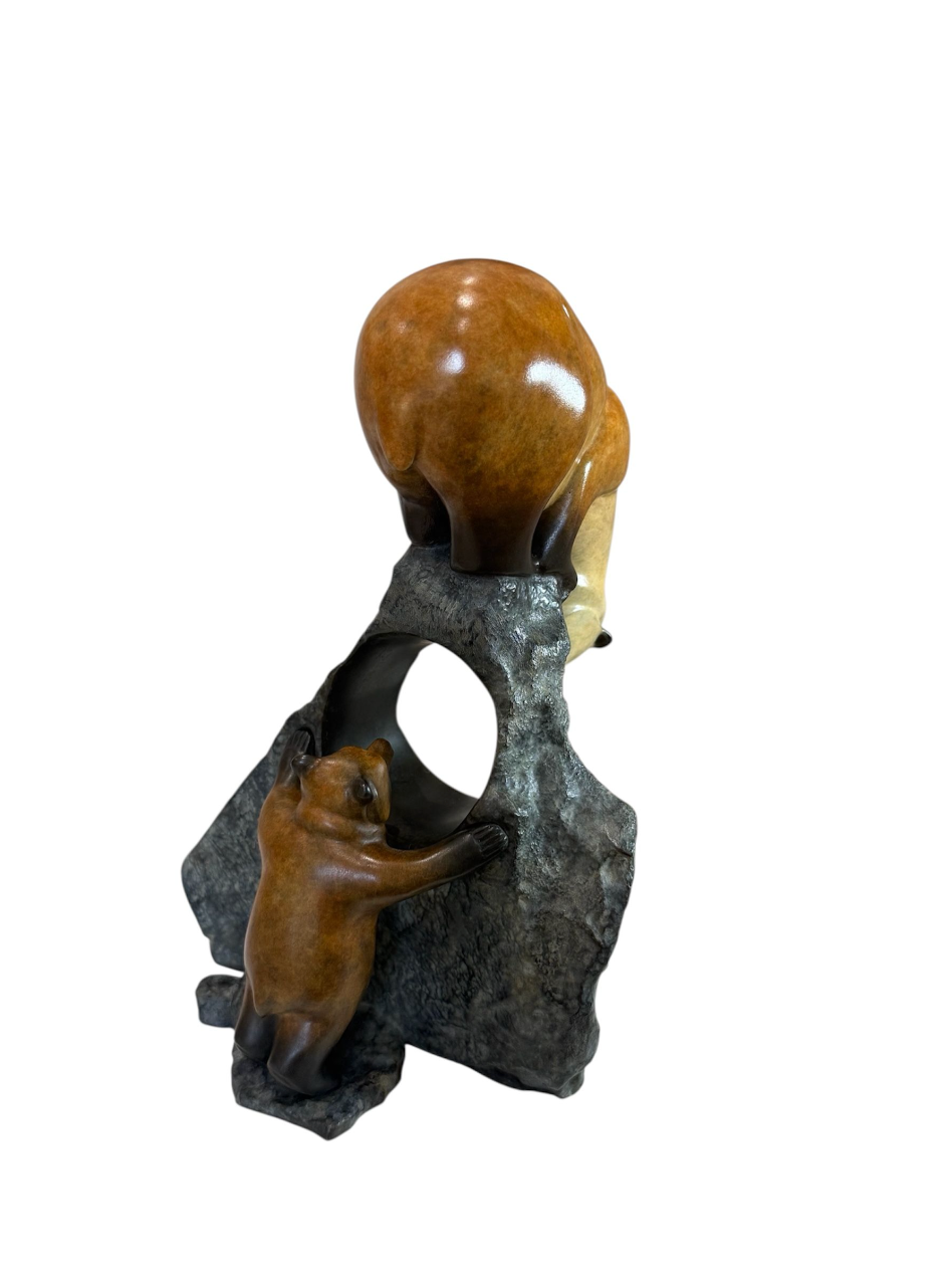 Decorative stone sculpture with a bear and a ball on a white background