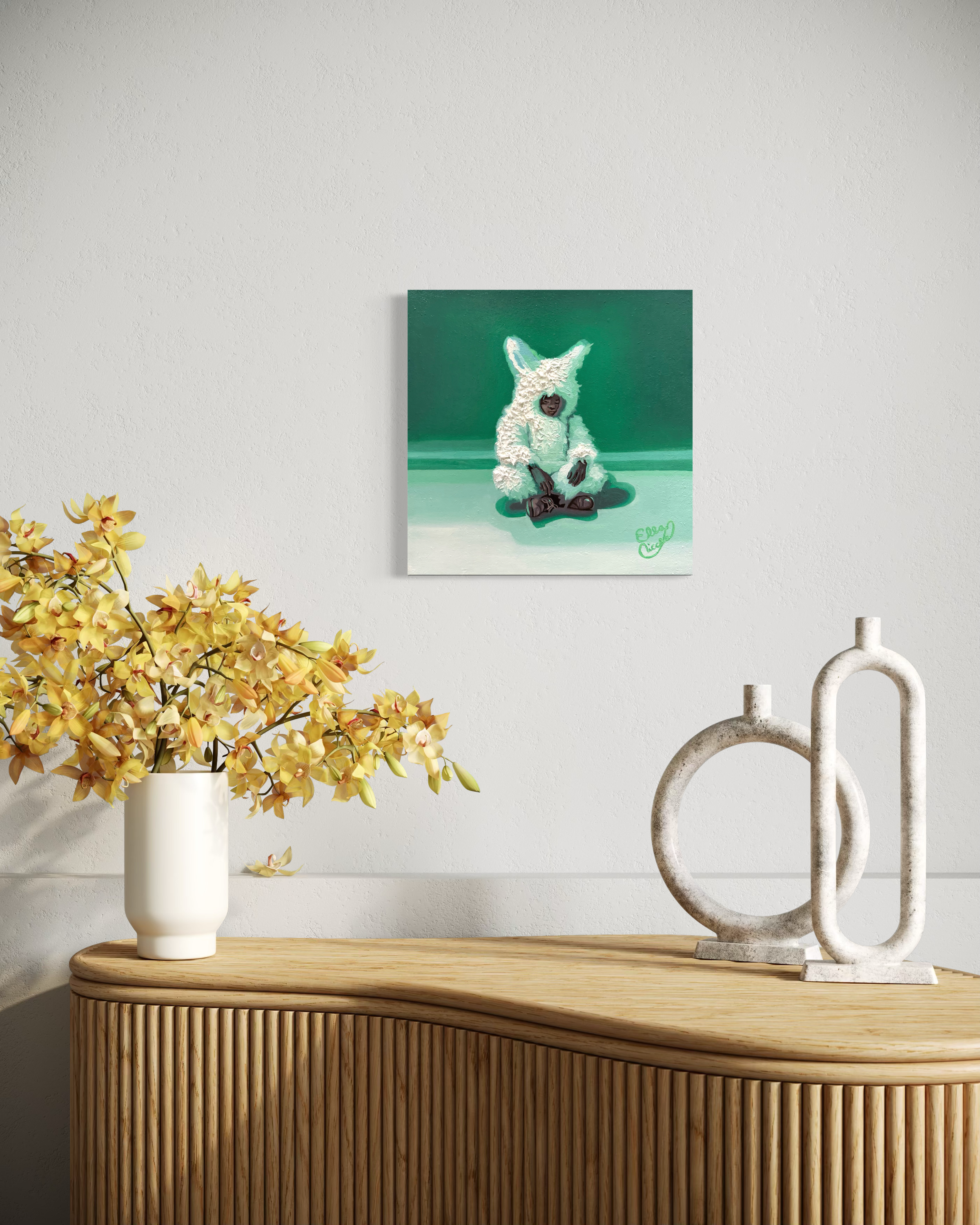 Decorative scene with a vase of yellow flowers, a sculpture, and a framed picture on a wooden surface.